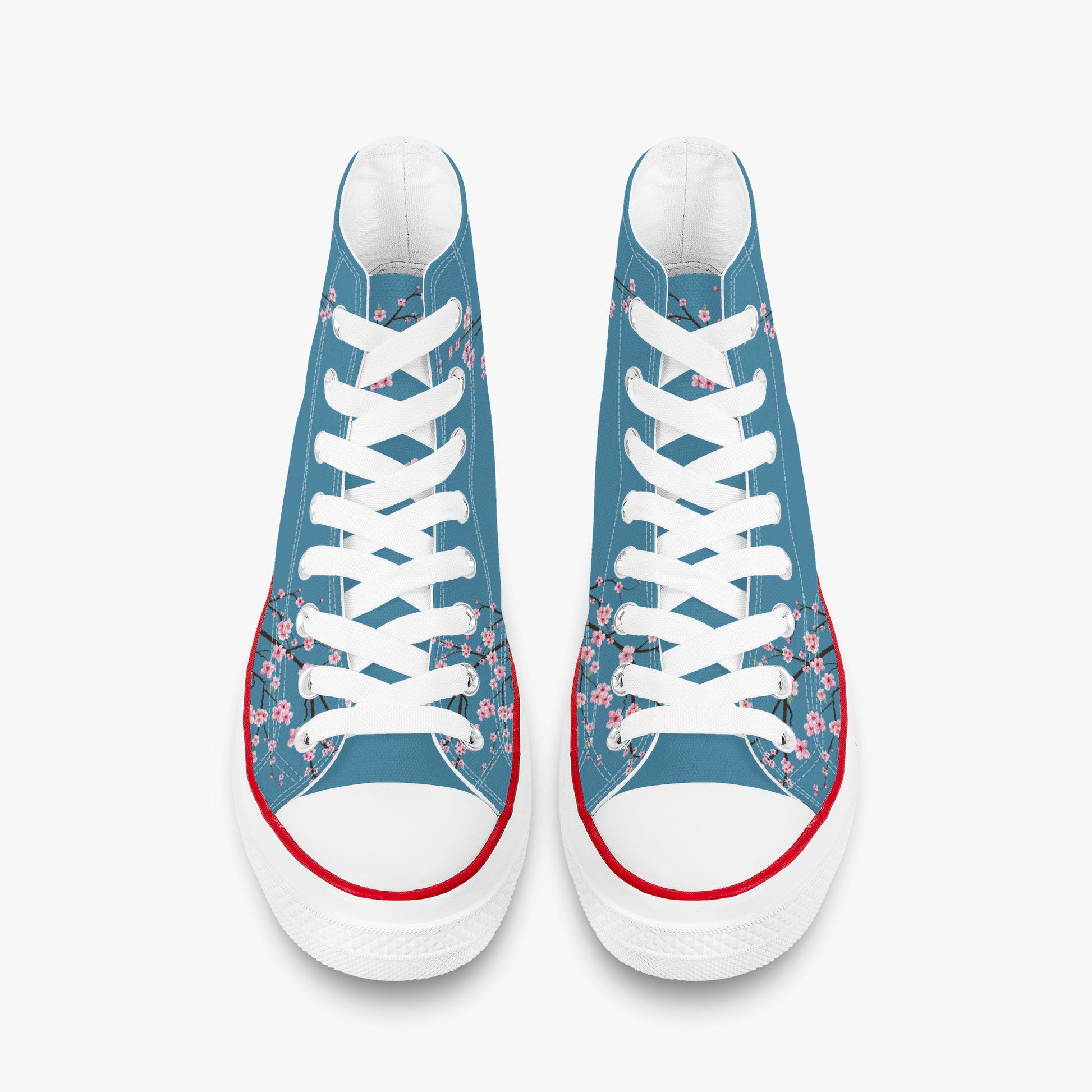 Pair of blue sneakers with floral patterns and white laces on a white background