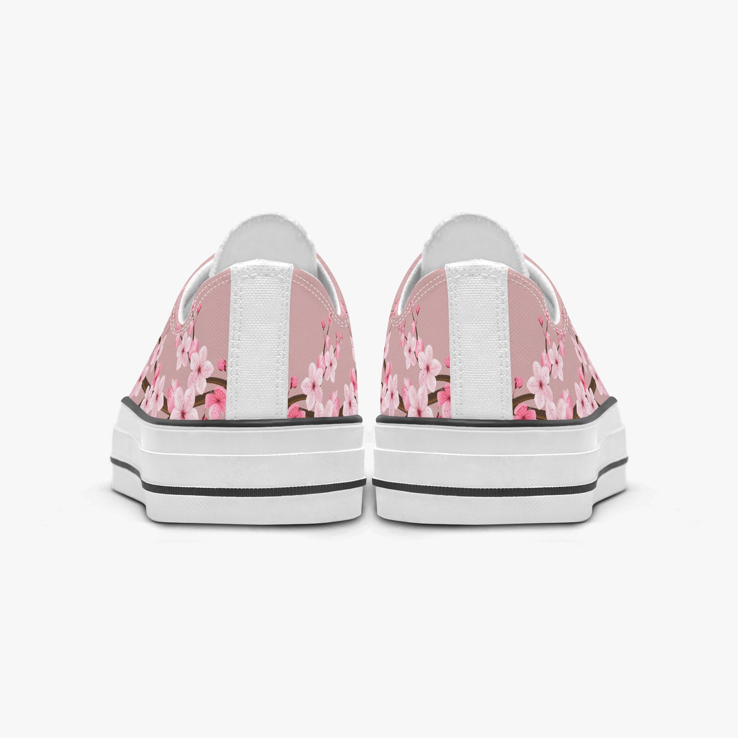 Pair of sneakers with pink floral pattern on a white background