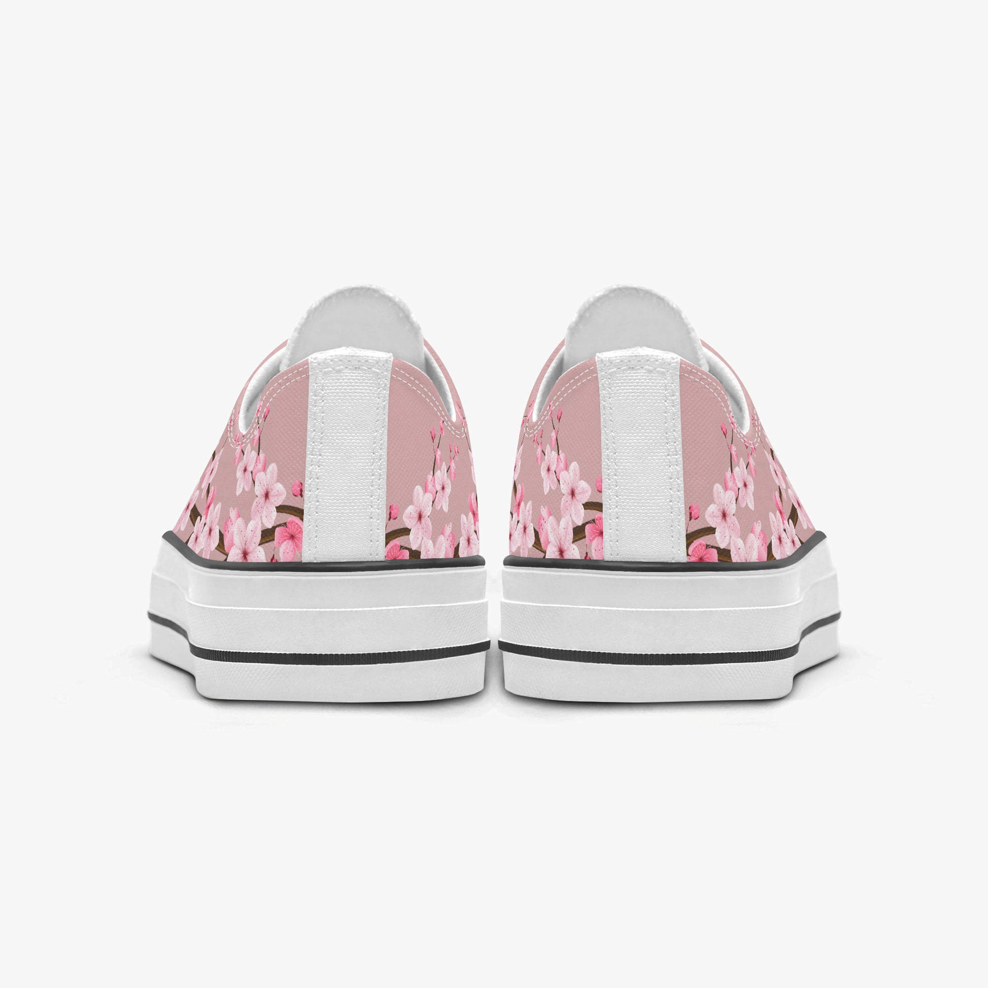 Pair of sneakers with pink floral pattern on a white background