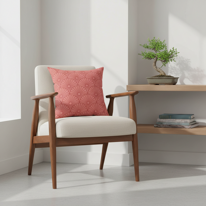 Wooden armchair with a red patterned pillow in a minimalistic room.