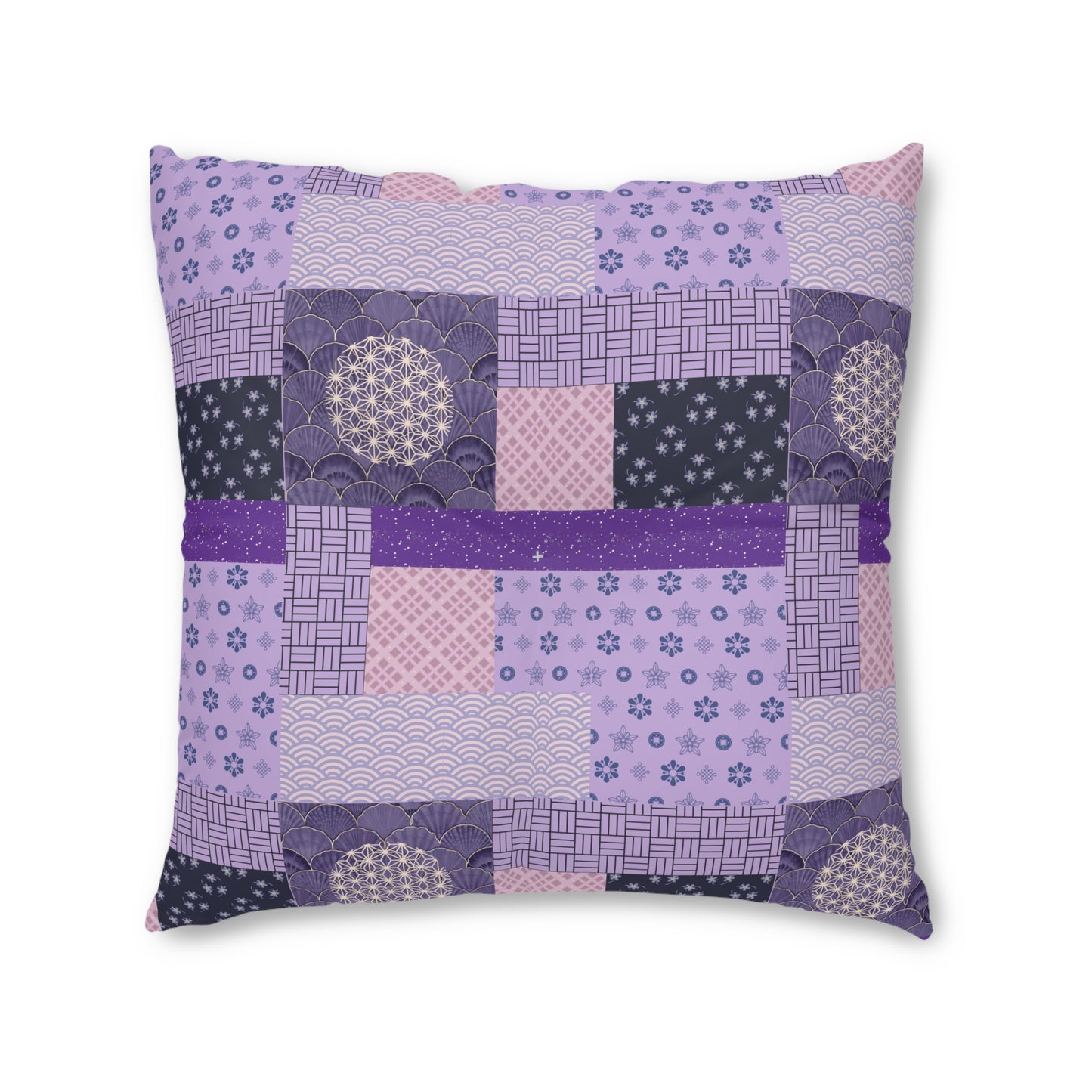 A square decorative throw pillow featuring a patchwork design of various purple, lavender, and dark navy Japanese-inspired patterns, including waves, fans, and geometric grids, set against a plain white background.