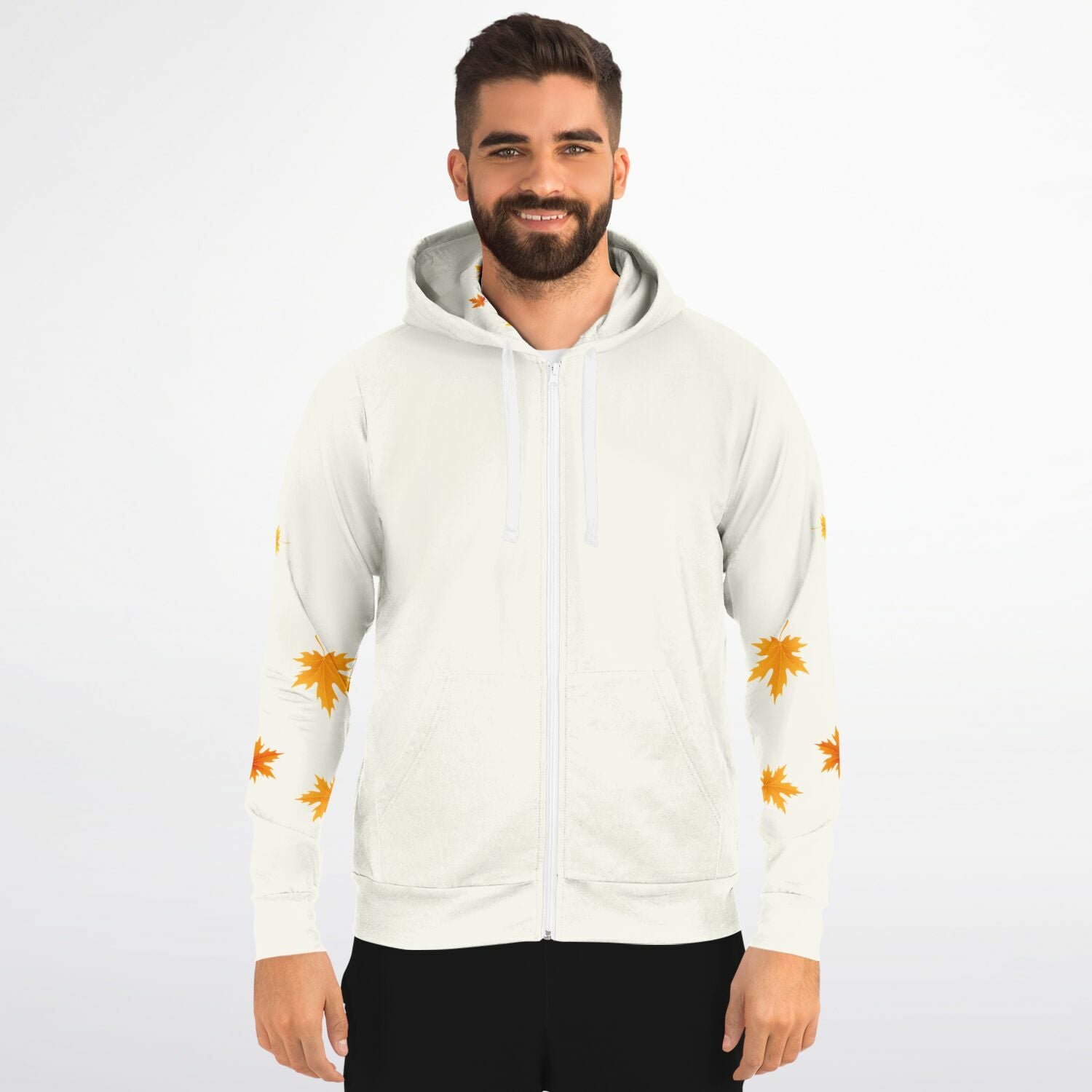 A man wearing a white zip-up hoodie with orange maple leaf prints on the sleeves, photographed against a plain light gray studio background.