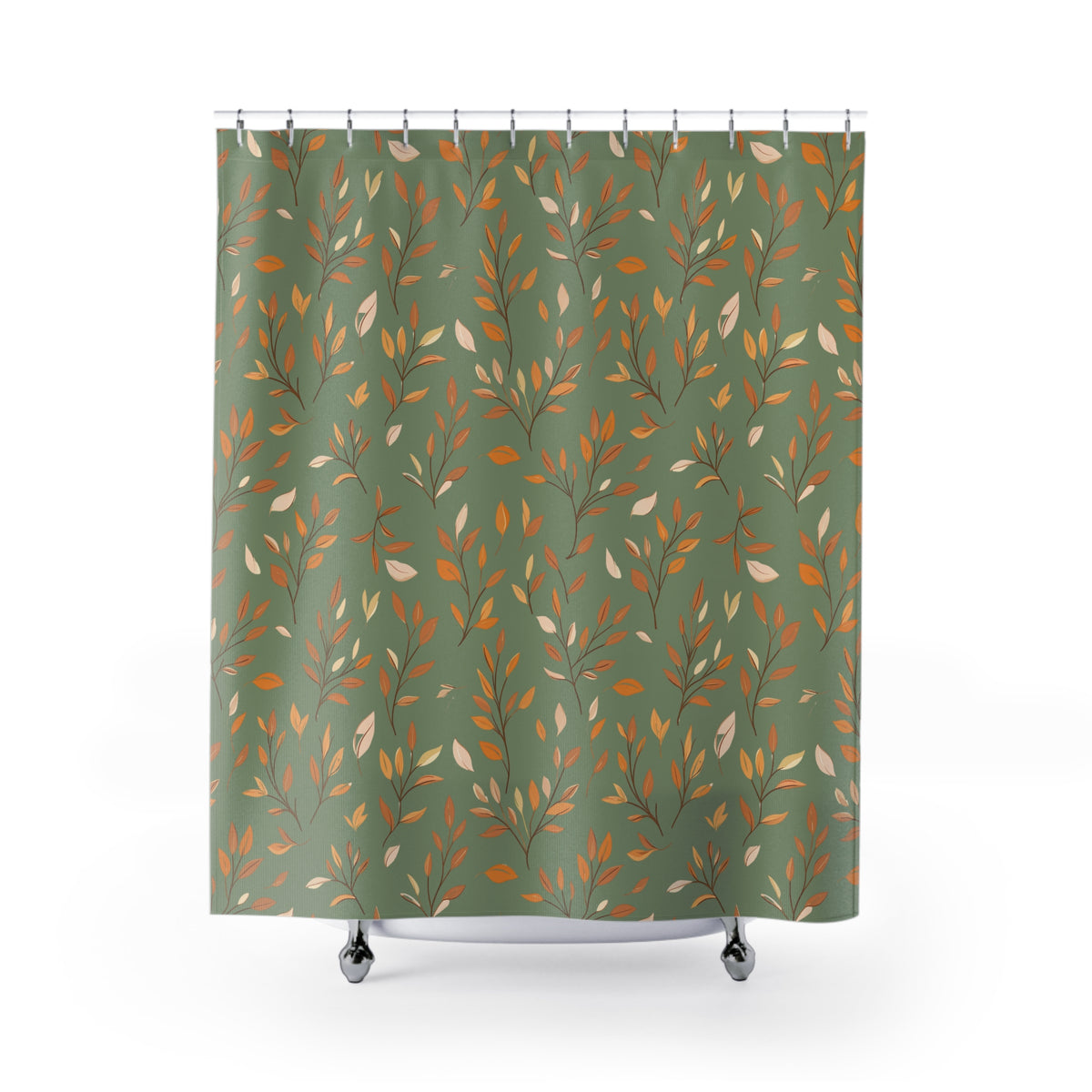 A shower curtain with a vertical pattern of thin branches and leaves in orange, beige, and brown on an olive green background, hanging from silver hooks over a white tub edge against a white studio background.