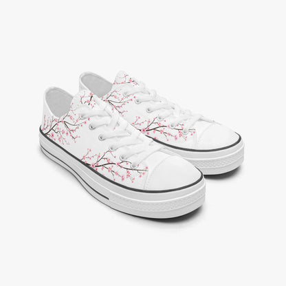 White sneakers with cherry blossom design on a white background