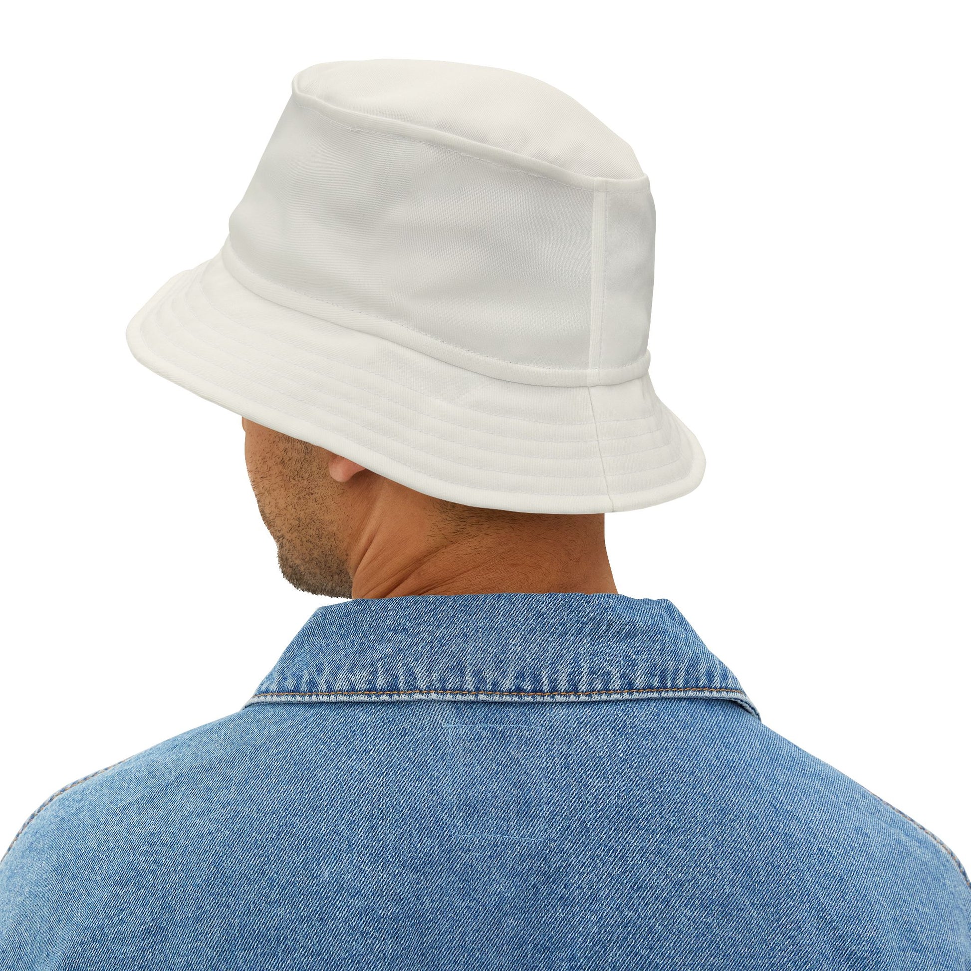 Person wearing a white bucket hat and blue denim shirt on a white background