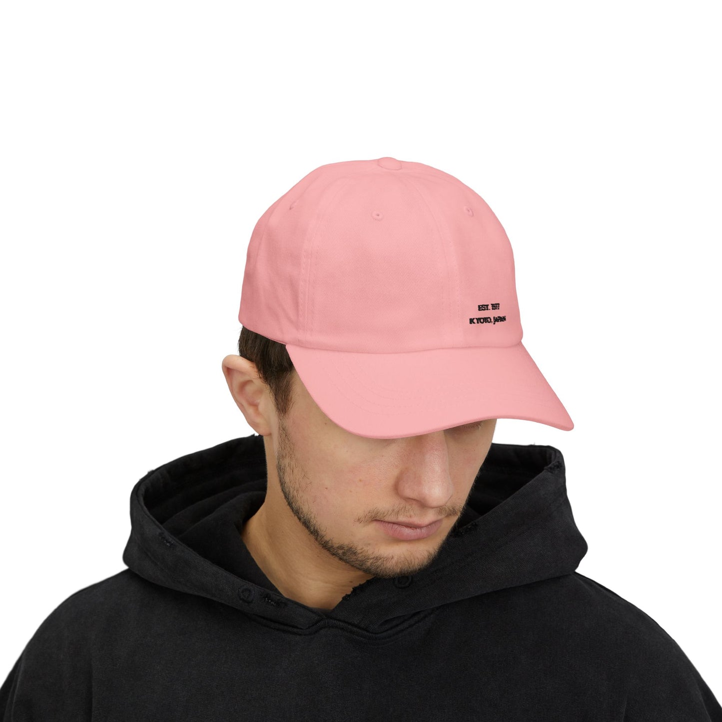 Person wearing a pink cap with a logo on a white background