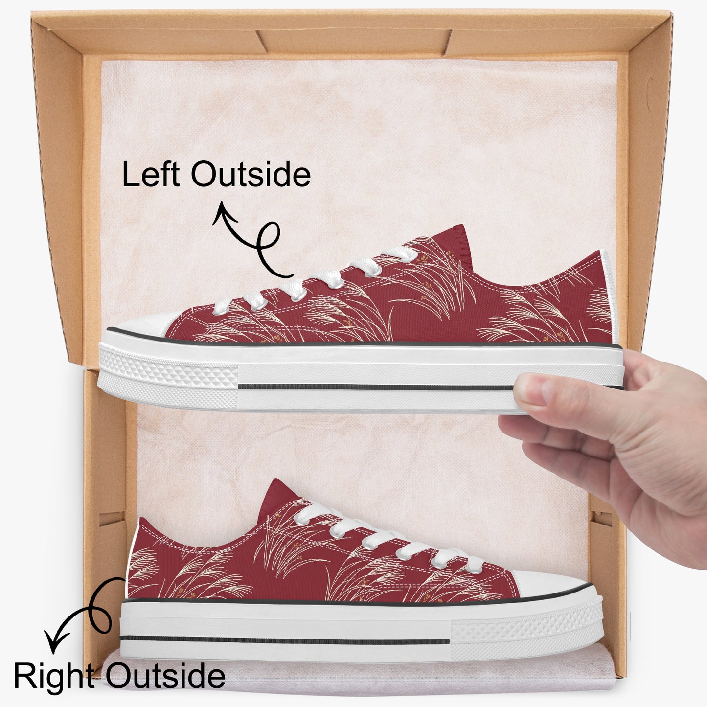A pair of low-top canvas sneakers with a red and white tropical palm leaf pattern, displayed inside a cardboard shoebox with a hand holding one shoe. Black text and arrows label the left and right shoes as 'Left Outside' and 'Right Outside'.
