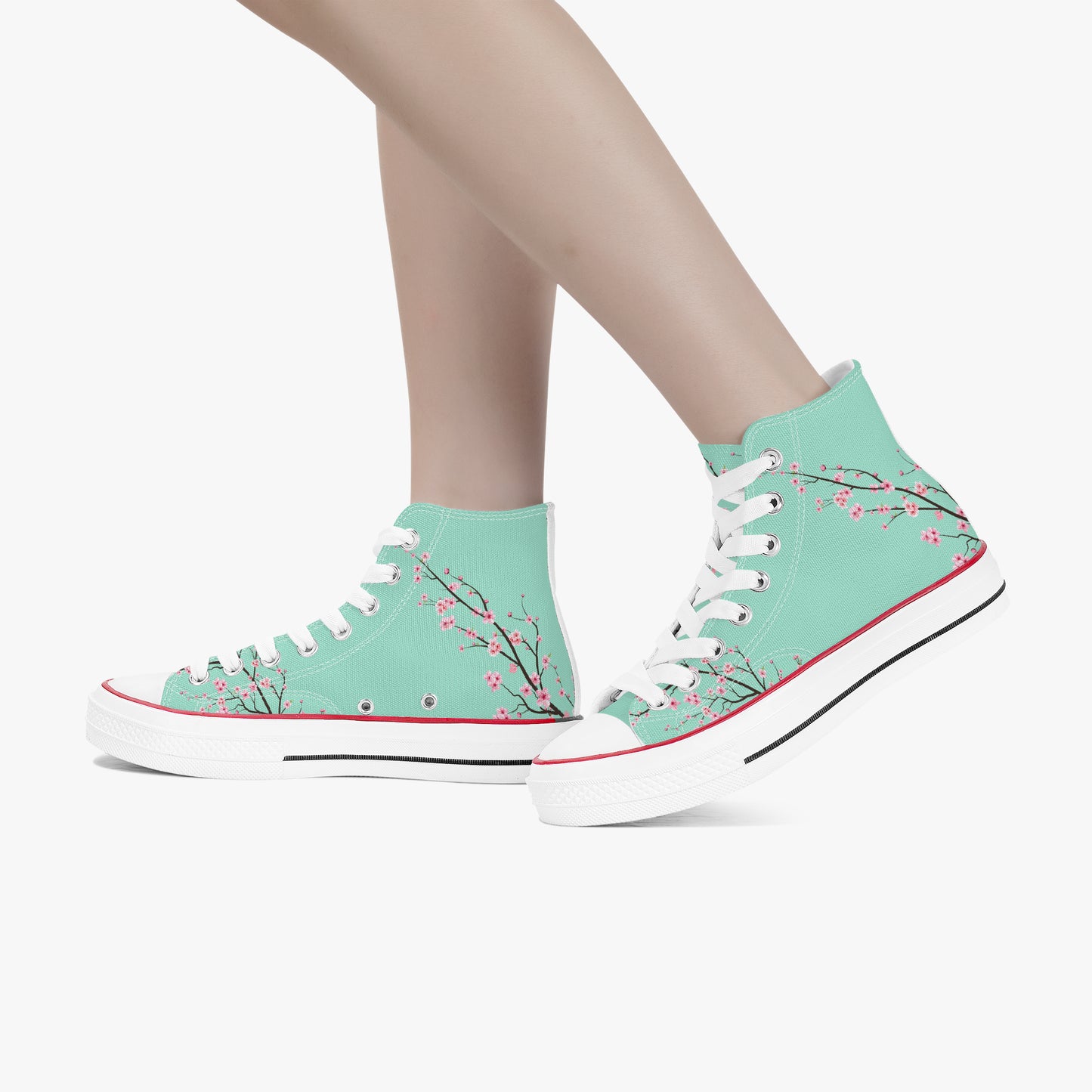 Teal high-top sneakers with floral design worn by a person on a white background