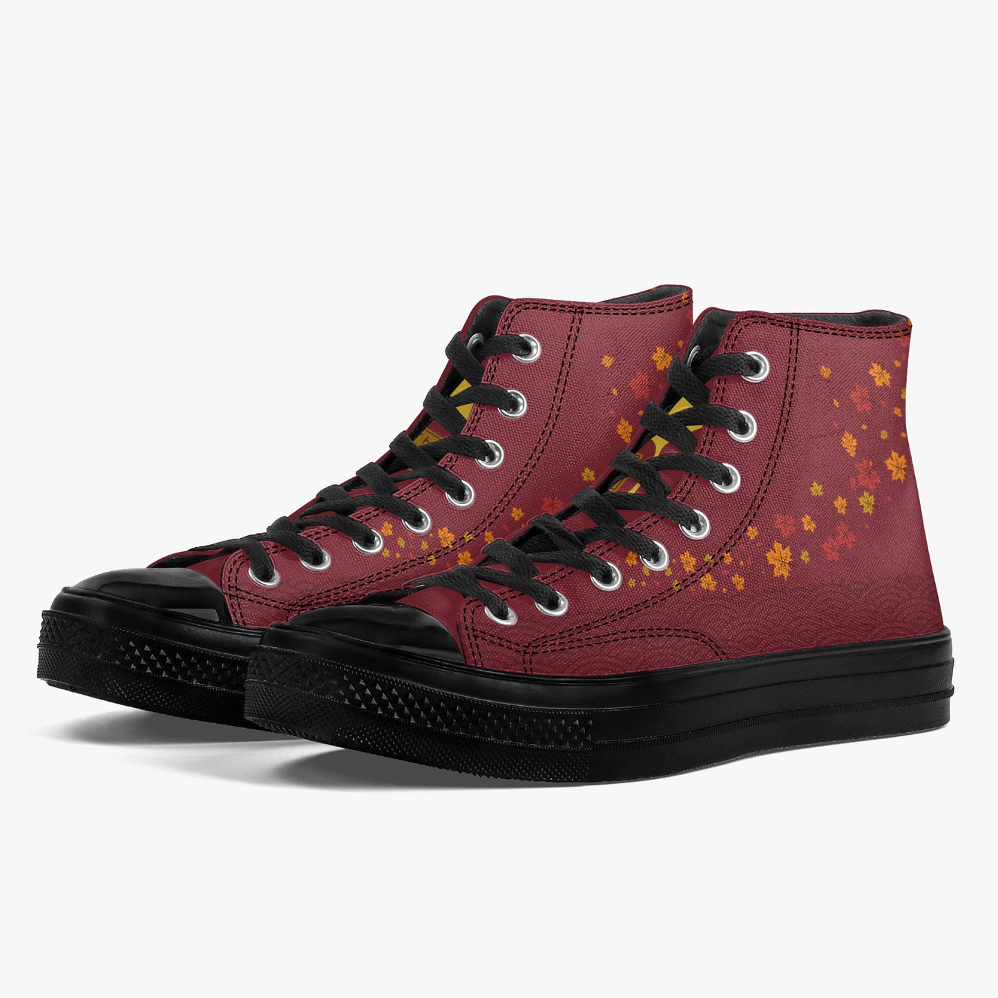 A pair of high-top sneakers in burgundy with black laces, black rubber toe caps and soles, and yellow-orange cherry blossom patterns on the side, shown against a light gray background.