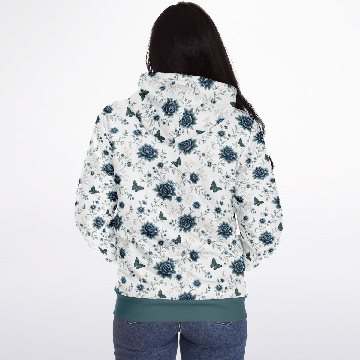 A woman viewed from behind wearing a white jacket with a blue floral and butterfly pattern, paired with blue jeans, against a plain white background.
