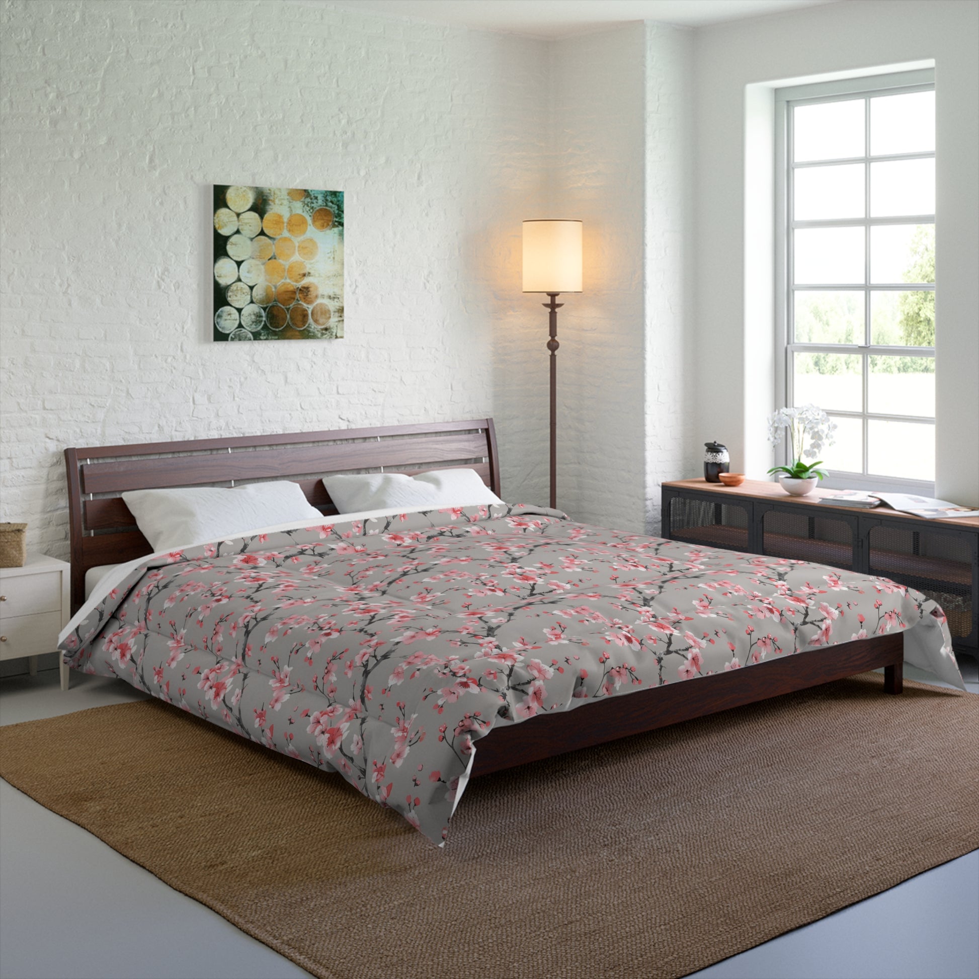 Bedroom with a bed, lamp, and artwork on a white wall.