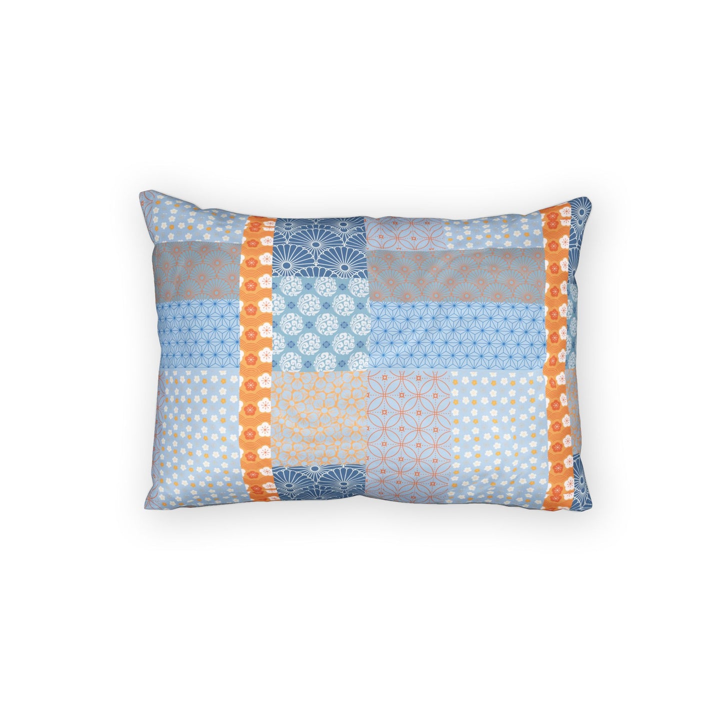 A rectangular throw pillow featuring a patchwork design of light blue, gray, and orange patterned fabric panels, set against a plain white background.