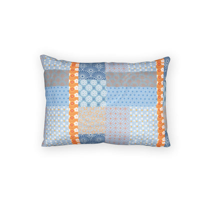 A rectangular throw pillow featuring a patchwork design of light blue, gray, and orange patterned fabric panels, set against a plain white background.