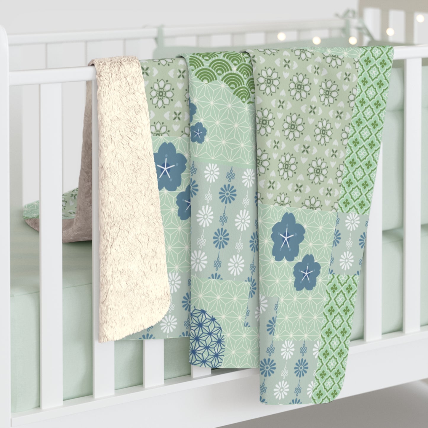 Three patterned baby blankets draped over a crib with a white background
