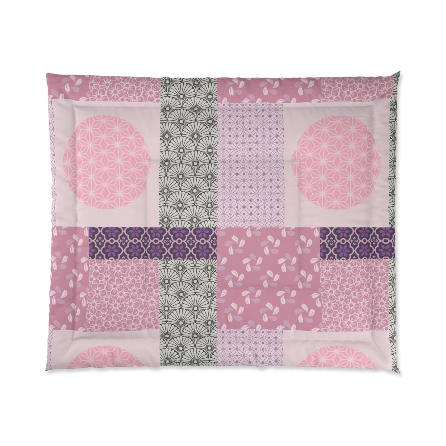 Patchwork quilt with pink, purple, and green patterns on a white background