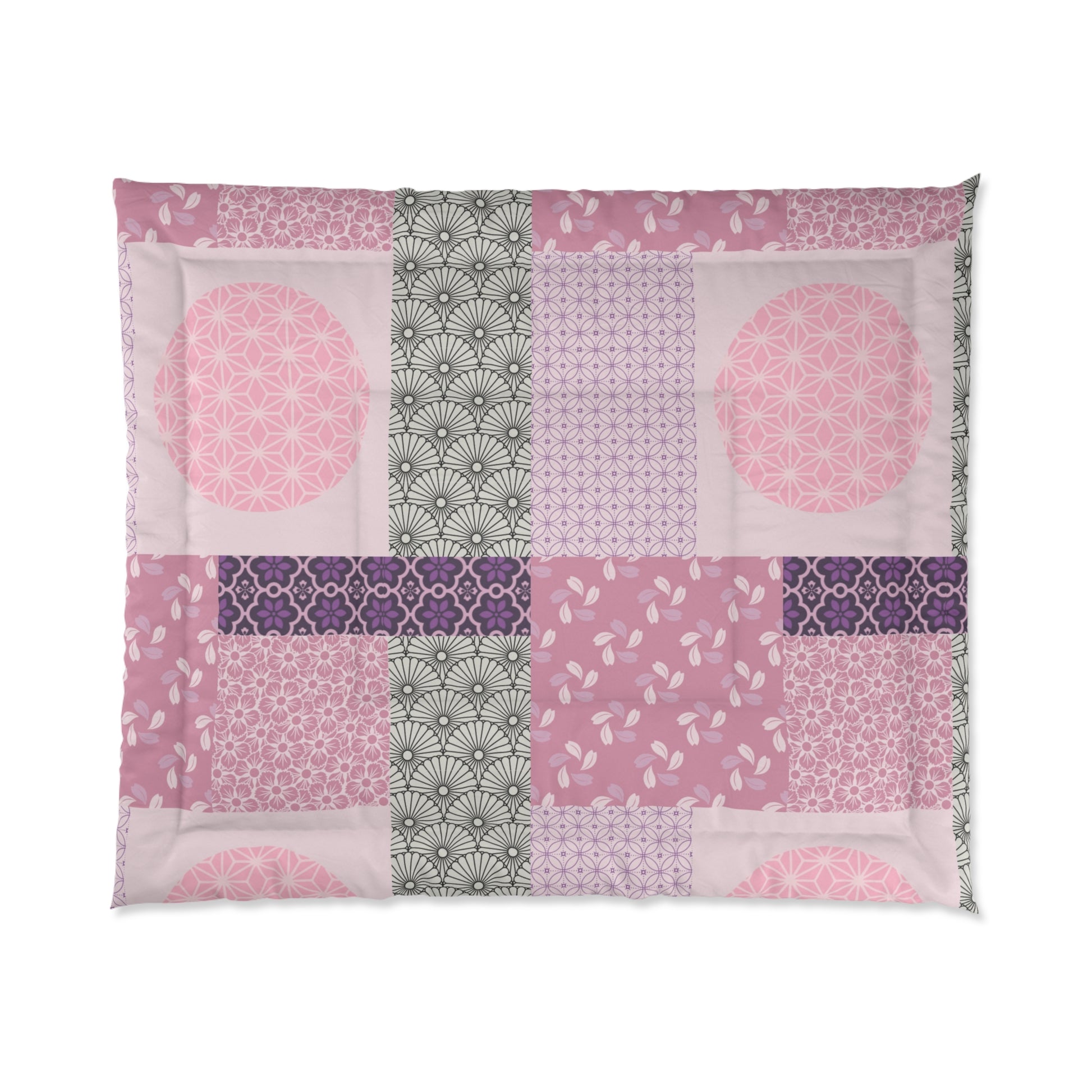 Patchwork quilt with pink, purple, and green patterns on a white background