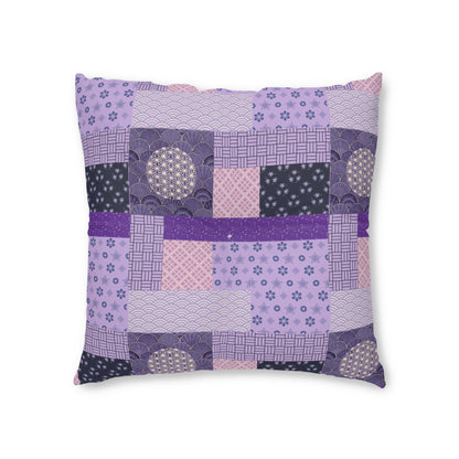 A square decorative throw pillow featuring a patchwork quilted design in shades of purple, pink, and navy with various Japanese-inspired patterns, shown against a plain white background.