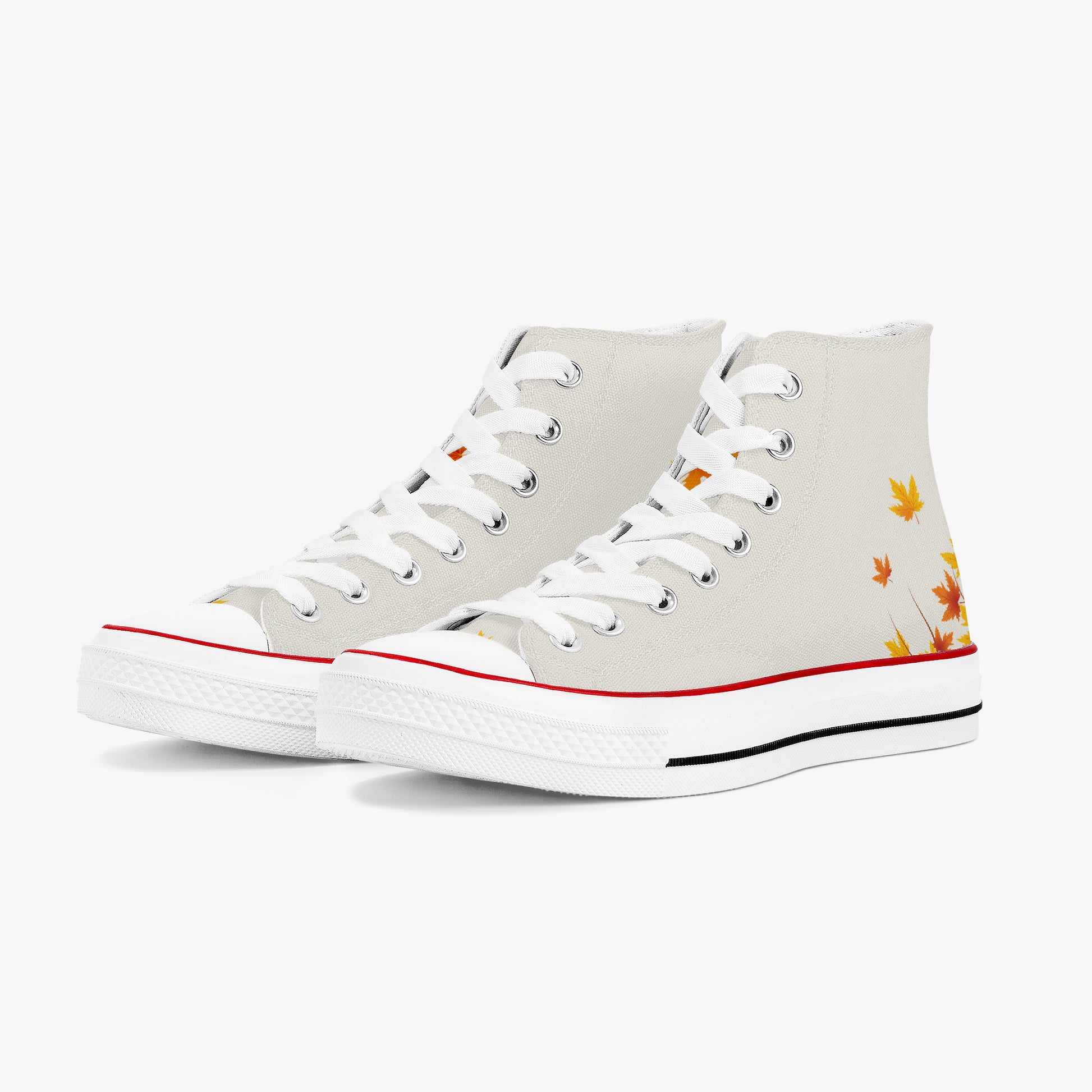 A pair of high-top canvas sneakers in off-white, featuring white laces, a red stripe along the toe, a black stripe along the midsole, and a small autumn leaf graphic in orange and yellow on the outer side.