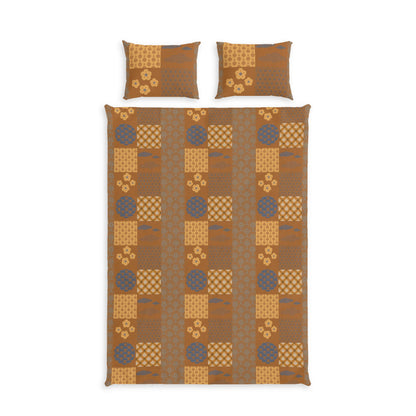 A bedding set featuring a patchwork quilt and two matching pillowcases with a geometric and floral pattern in shades of brown, tan, and muted blue-gray, displayed on a solid white background.