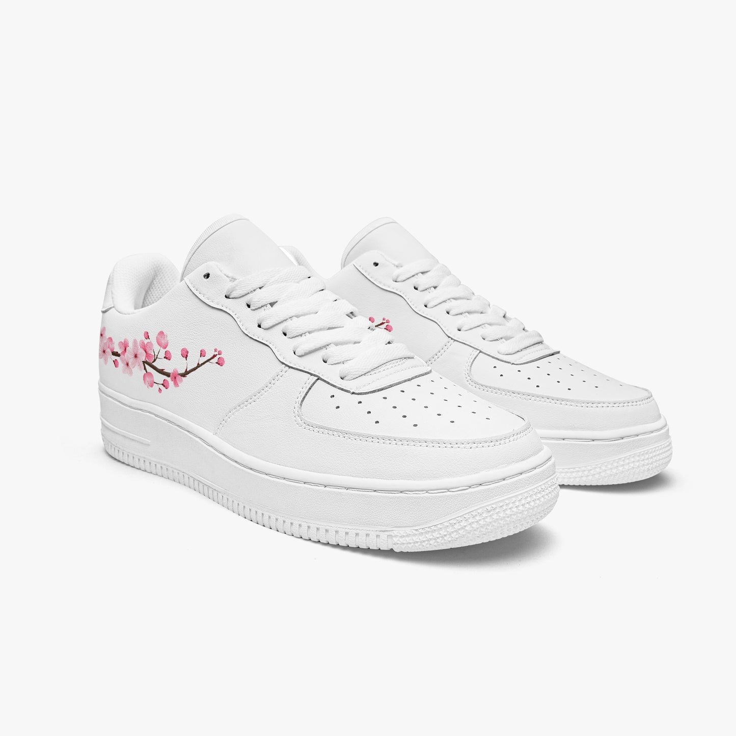 White sneakers with cherry blossom design on a white background