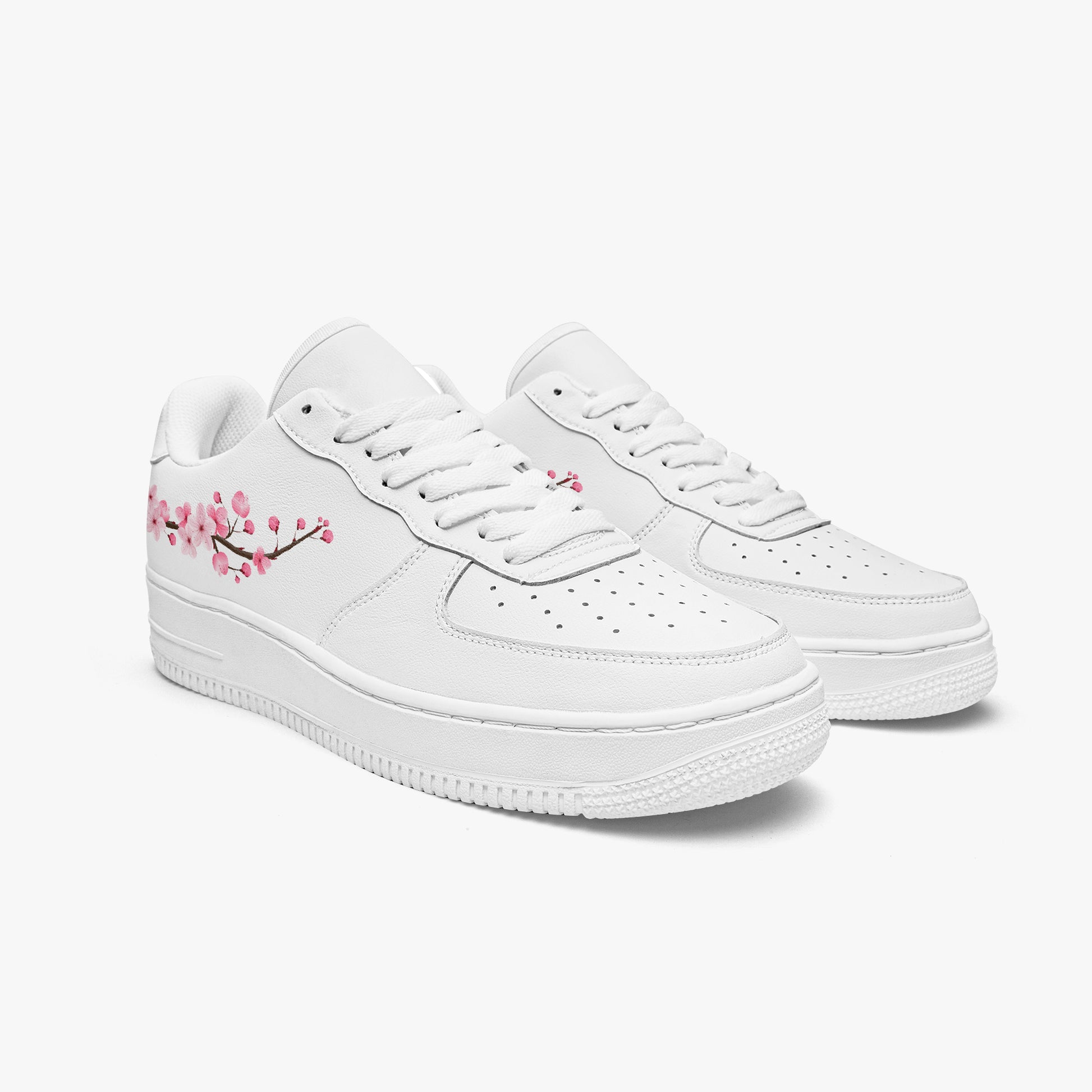White sneakers with cherry blossom design on a white background