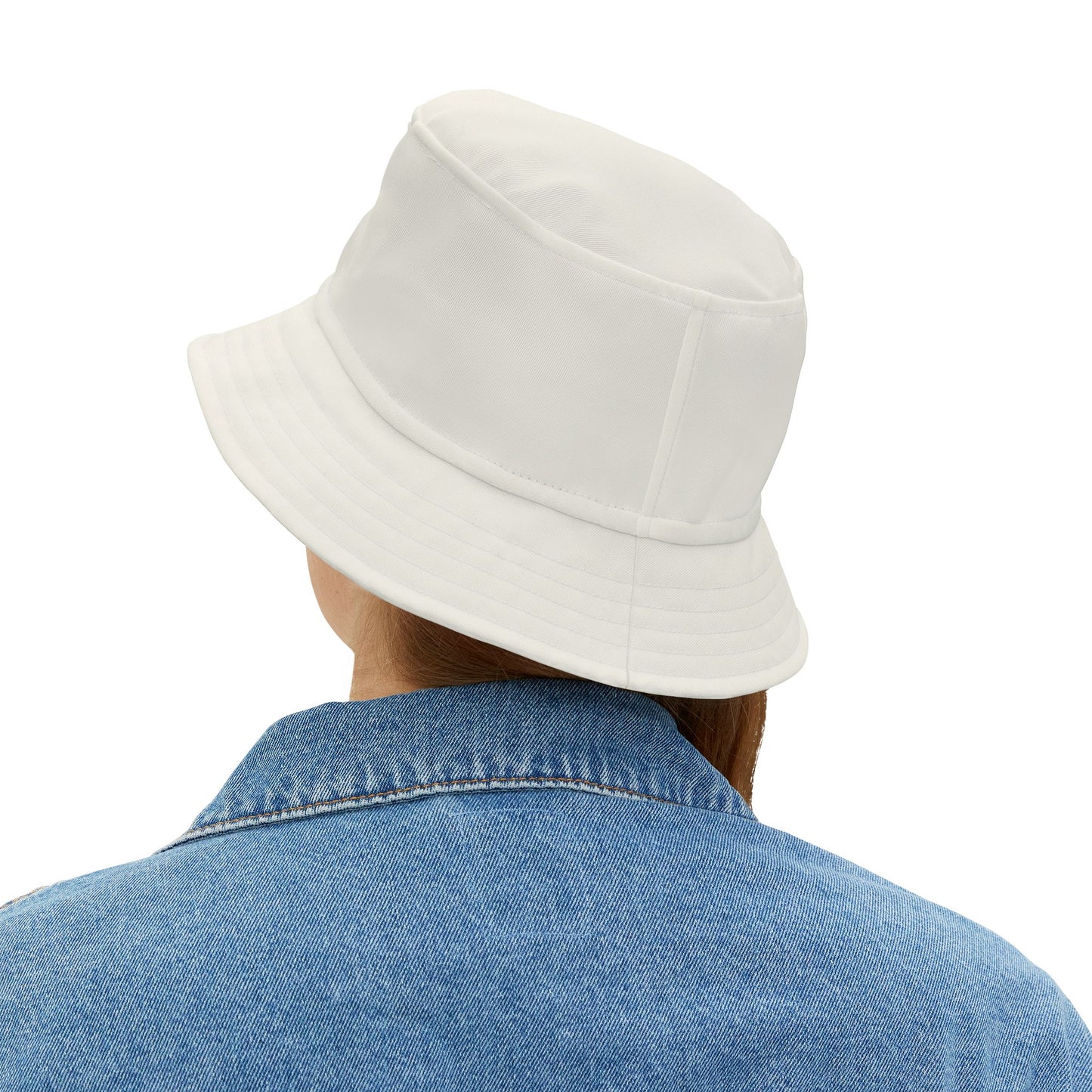 Person wearing a white bucket hat and blue denim jacket on a white background