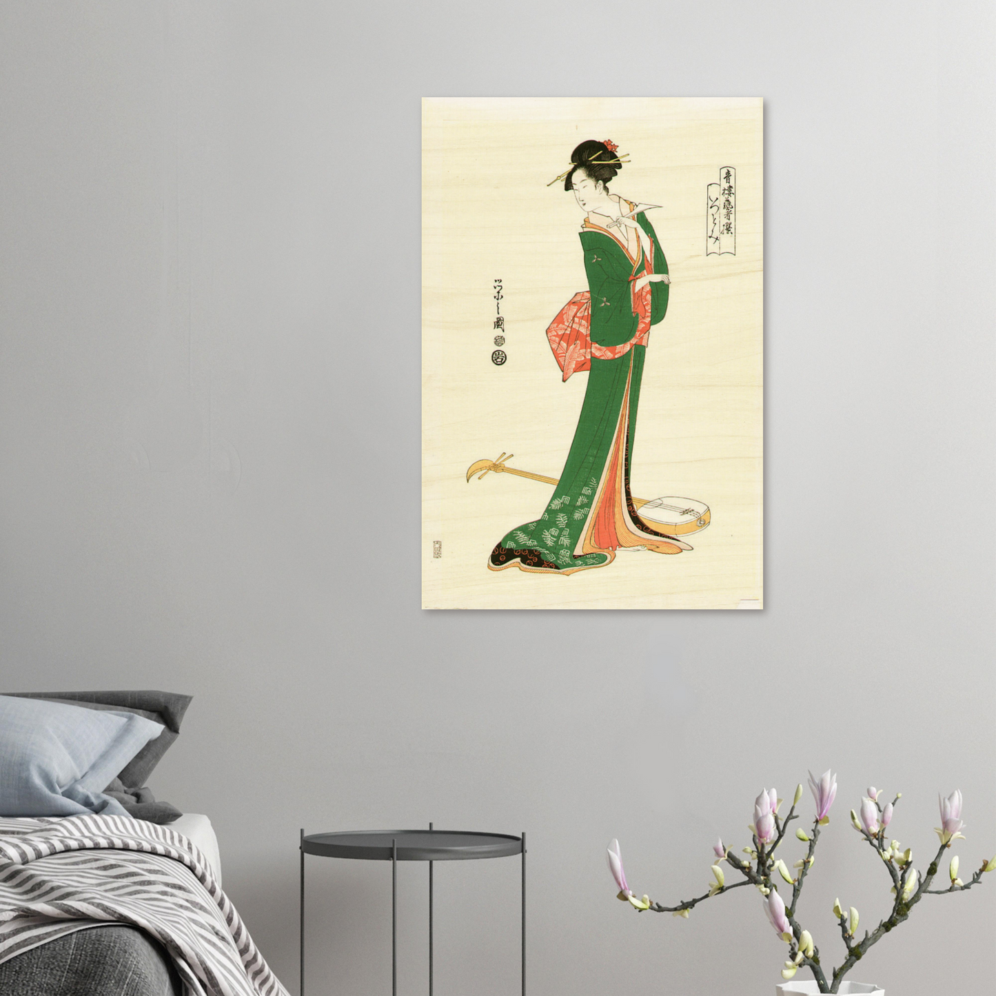 Framed artwork of a traditional Japanese woman in a green kimono on a gray wall.
