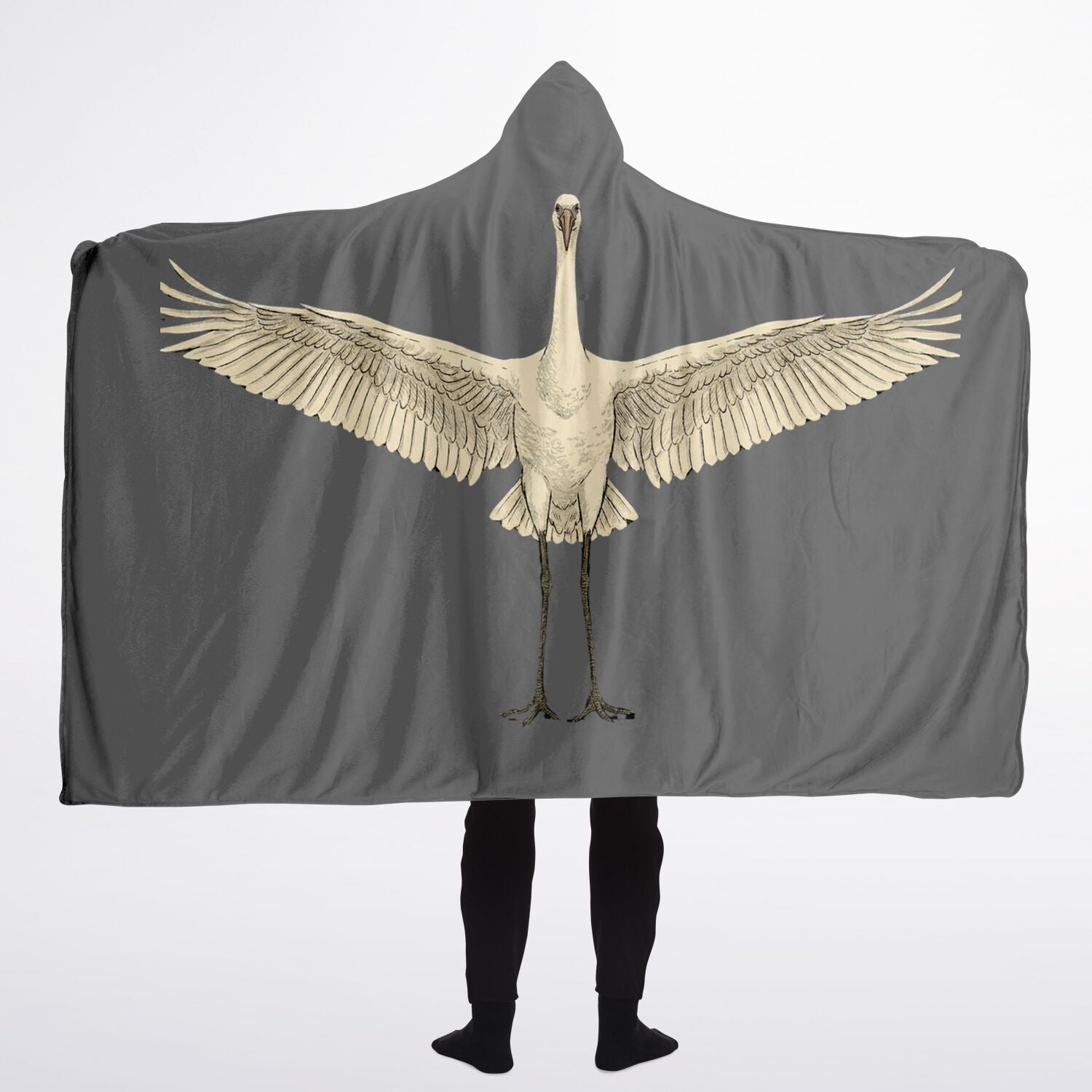 Person wearing a gray hooded blanket with a bird design on a white background