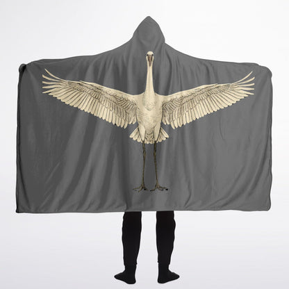 Person wearing a gray hooded blanket with a bird design on a white background