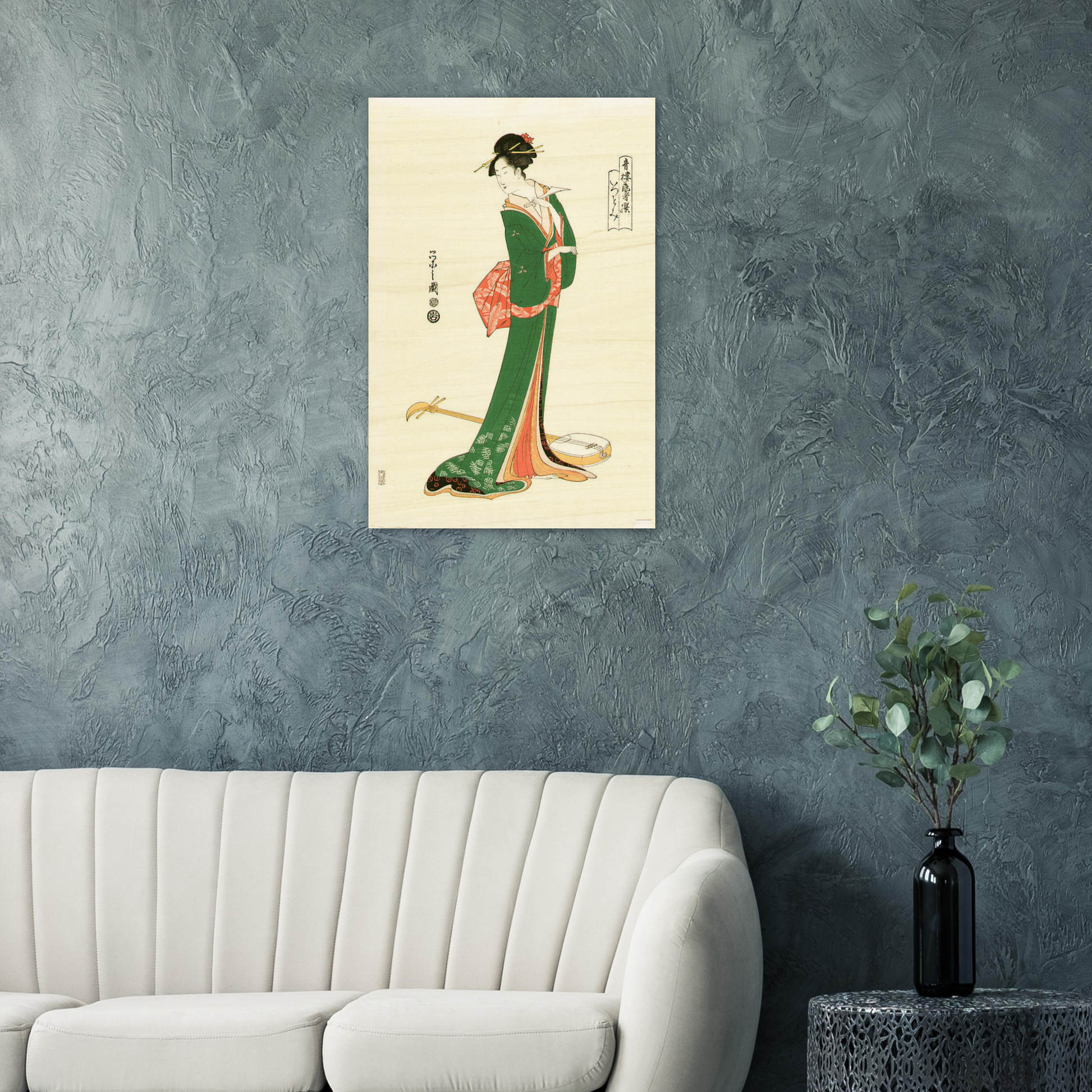 Japanese artwork of a woman in traditional attire on a gray wall above a white sofa.