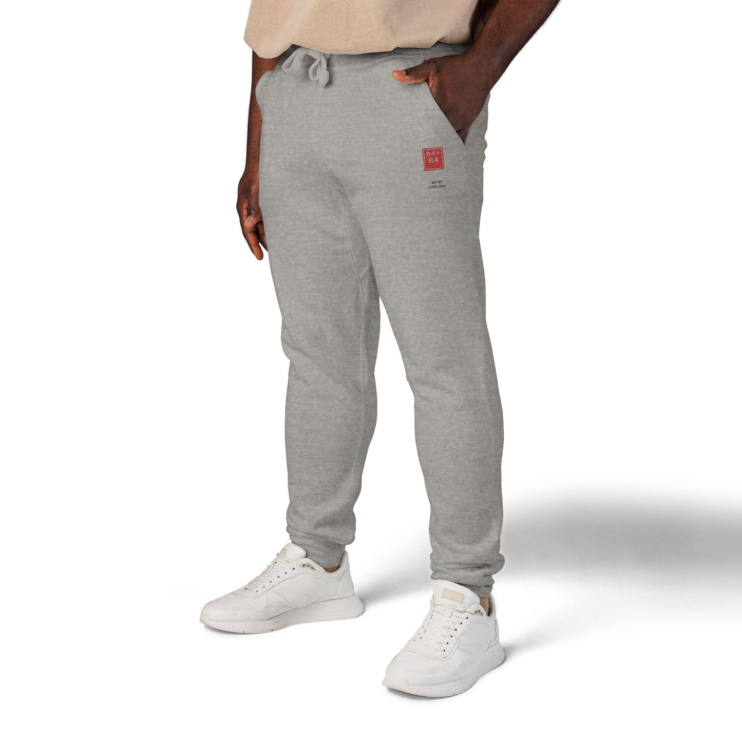 Person wearing gray sweatpants with a red logo on a white background