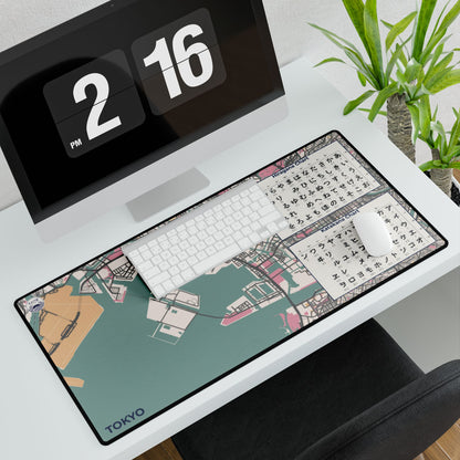 A high-quality large desk mat featuring a minimalist street map of Tokyo, Japan, in a vintage cartography style, laid out on a professional executive desk.