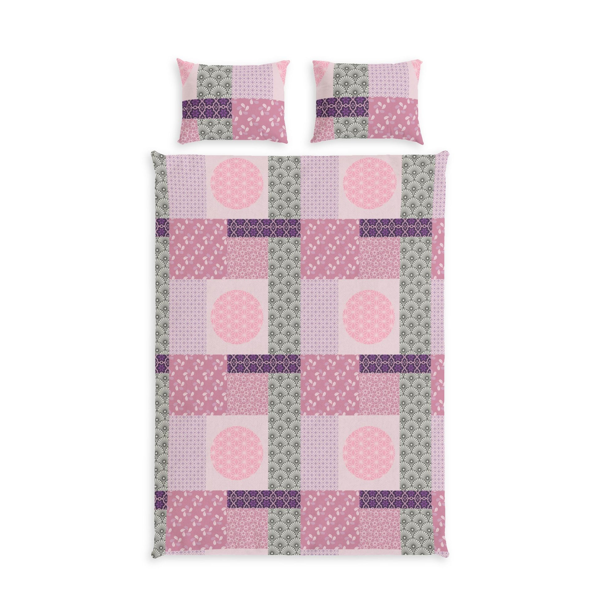 A bedding set featuring a patchwork quilt and two matching pillowcases in shades of pink, purple, and sage green, displayed on a clean white background.