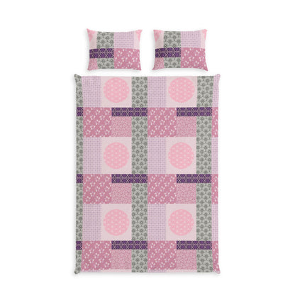 A bedding set featuring a patchwork quilt and two matching pillowcases in shades of pink, purple, and sage green, displayed on a clean white background.