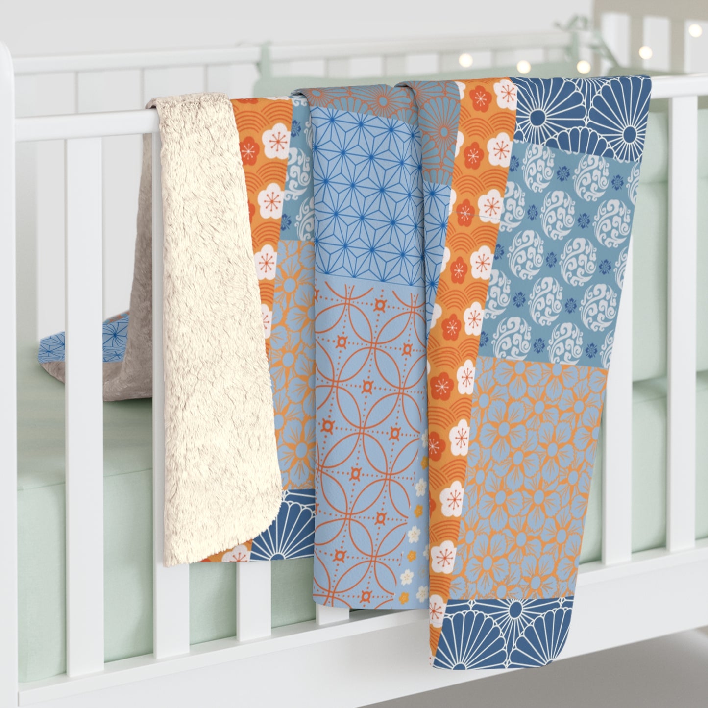 Colorful patterned baby quilt draped over a crib