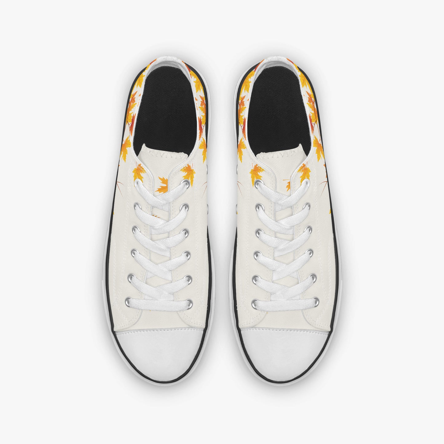 A pair of low-top canvas sneakers shown from a top-down view. The shoes feature an off-white canvas upper with a black rubber toe cap and sole edge, white laces, and a yellow and orange flame pattern printed around the collar.