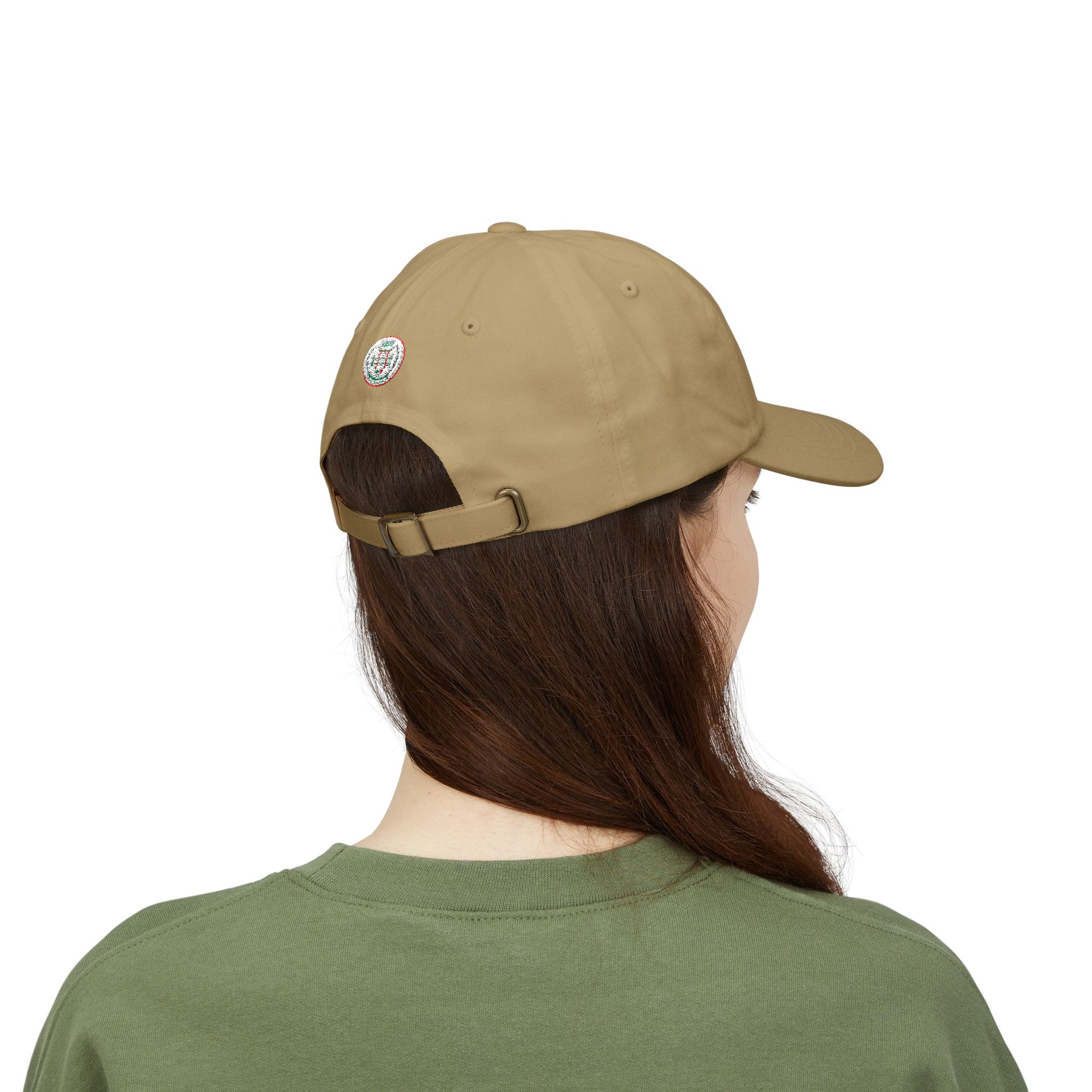 Person wearing a beige cap and green shirt on a white background