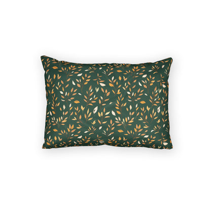 A rectangular throw pillow with a dark green background featuring a repeating pattern of small leaves in mustard yellow and off-white, shown against a plain white background.