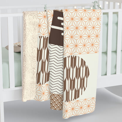 Set of patterned blankets hanging on a crib