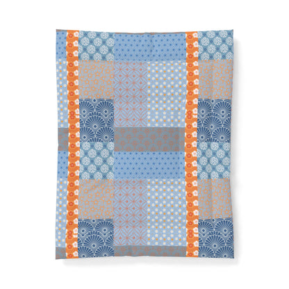 Patterned fabric with blue, orange, and gray colors on a white background. Heritage Cotton