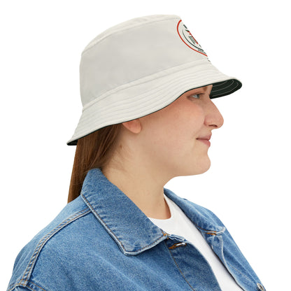 Person wearing a light gray bucket hat with a logo on a white background