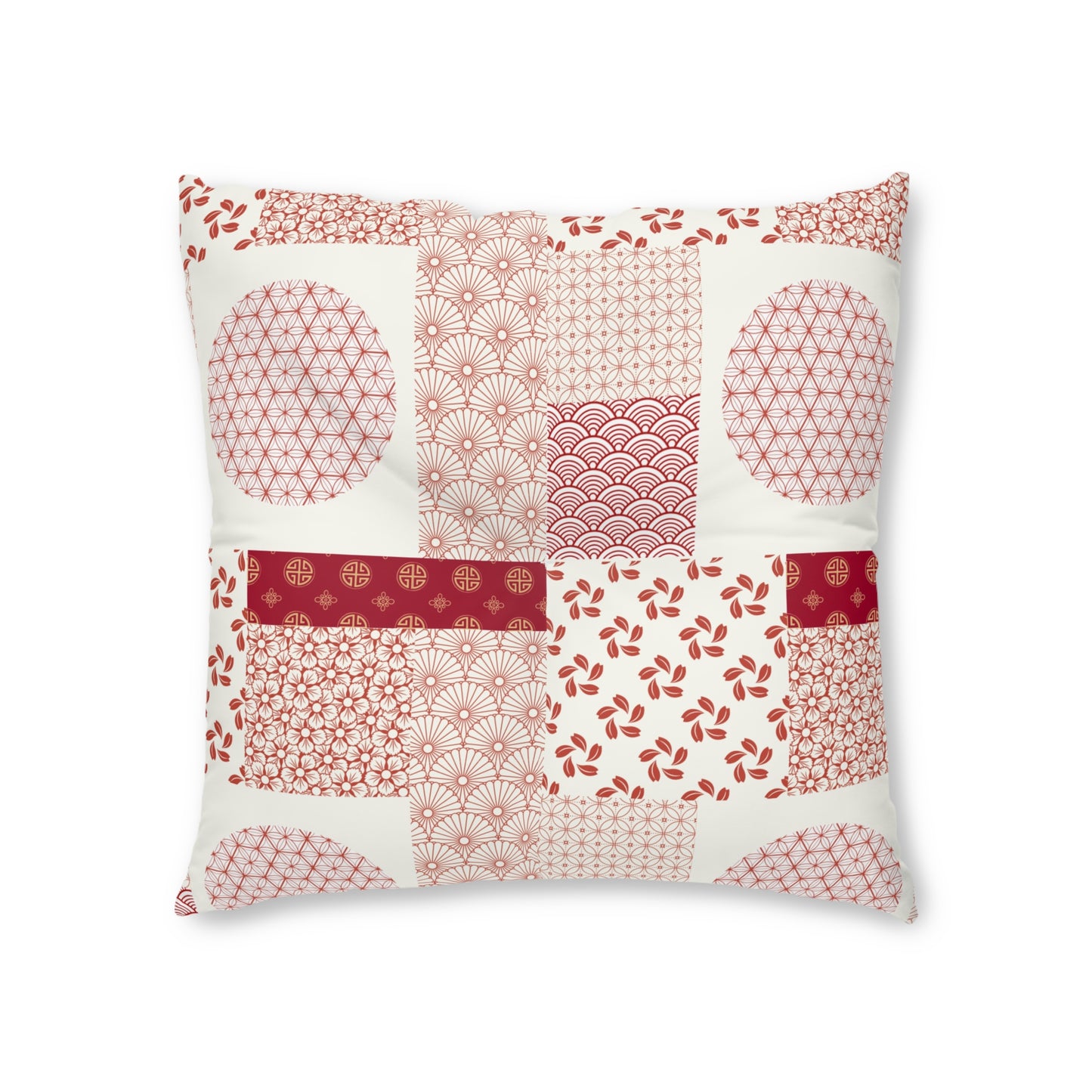 A square decorative throw pillow featuring a patchwork design of various Japanese-inspired patterns in shades of red, pink, and beige on an off-white background.