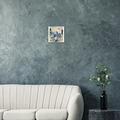 Sofa in a room with a textured gray wall, a small painting, and a plant on a side table.