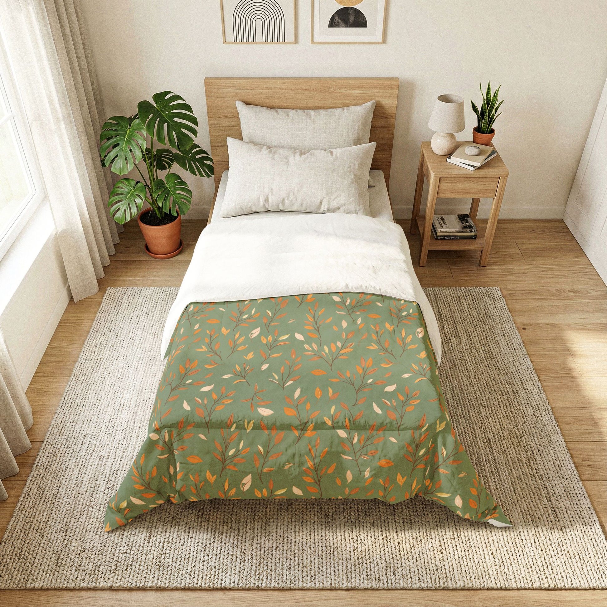 A neatly made bed in a bright, modern bedroom featuring a green and pink botanical patterned comforter, white sheets, and a light wood headboard. The bed is placed on a large woven jute rug next to a wooden side table with a lamp and books, and a large green plant in a terracotta pot sits near the window.