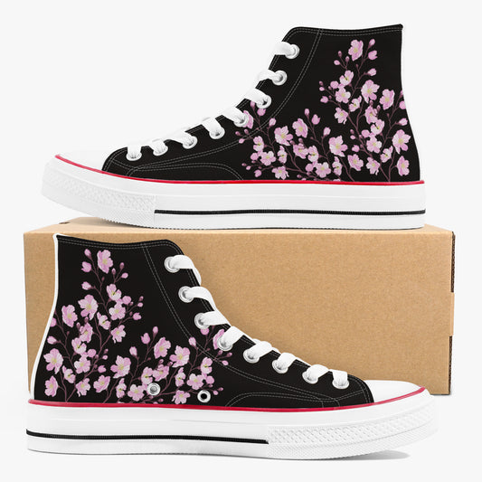 Black high-top sneakers with pink floral pattern on a cardboard box