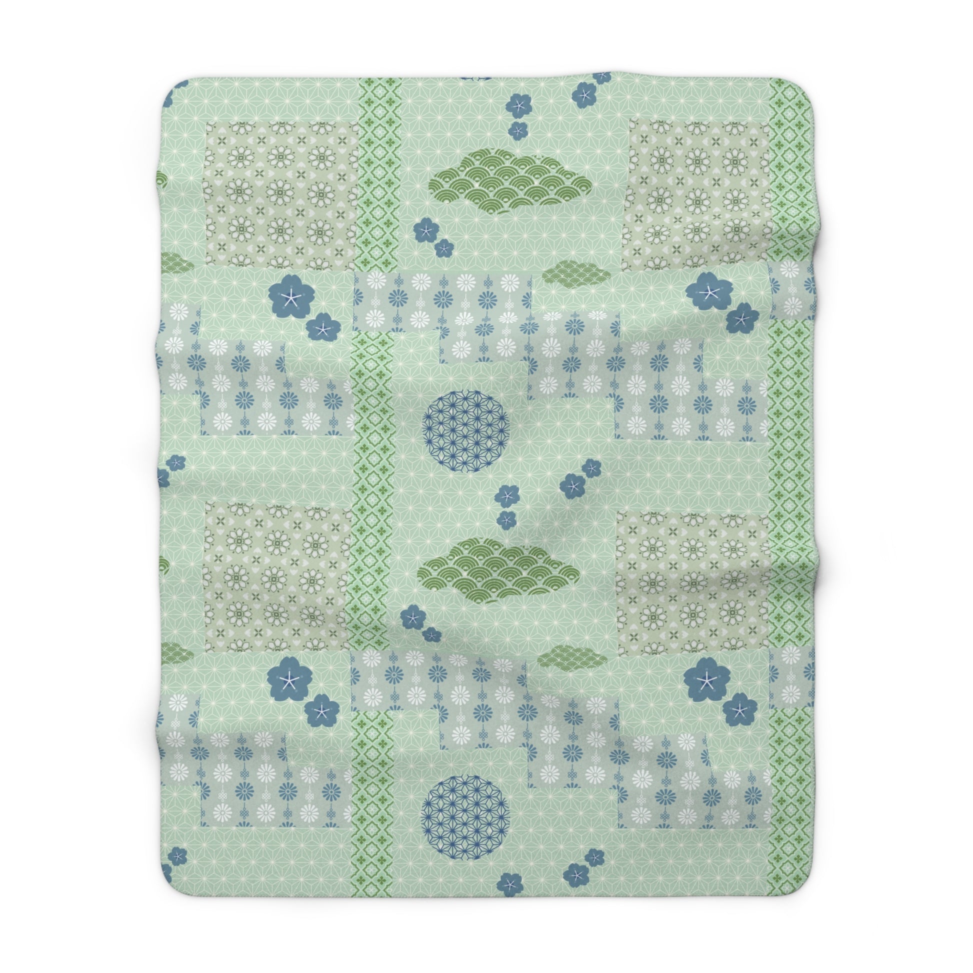 Patchwork blanket with geometric patterns on a light green background