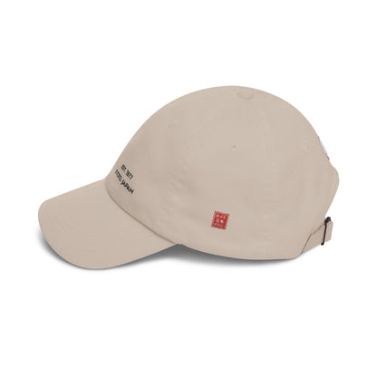 Beige baseball cap with embroidered text and logo on a white background