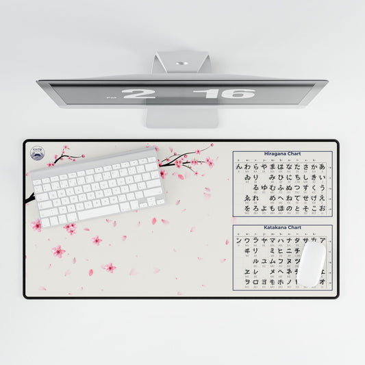 Desk mat with cherry blossom design and keyboard, computer monitor on a white background