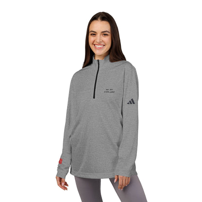 Woman wearing a gray Adidas pullover with a logo on a white background