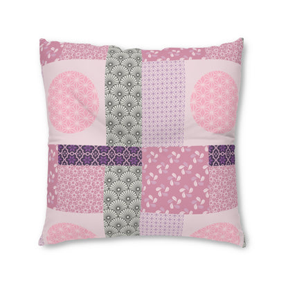 A square decorative throw pillow featuring a patchwork design of various pink, purple, and gray Japanese-style patterns, set against a plain white background.